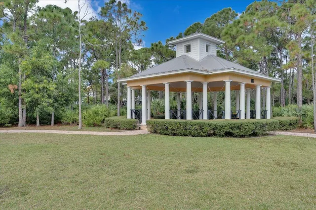 a view of a swimming pool with lounge chairs in patio