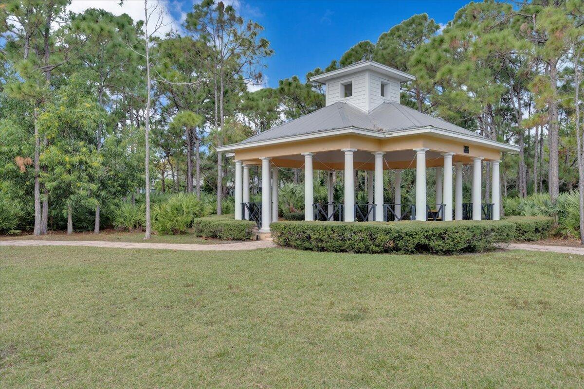120 West Bay Cedar Circle Jupiter, FL 33458 - Photo 31 of 33 a view of a white house with a big yard and large trees
