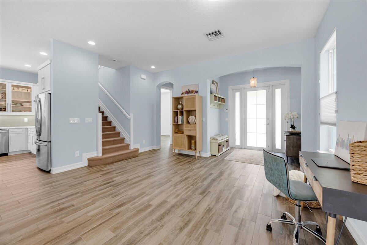 120 West Bay Cedar Circle Jupiter, FL 33458 - Photo 4 of 33 a view of a livingroom with wooden floor and stairs