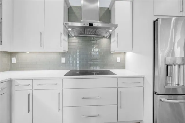 a kitchen with appliances cabinets and a counter top space