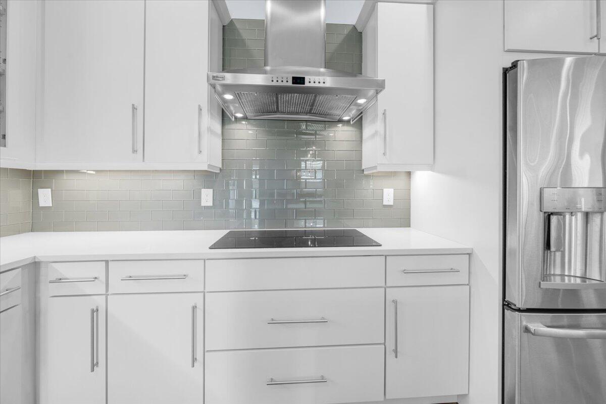 120 West Bay Cedar Circle Jupiter, FL 33458 - Photo 10 of 33 a kitchen with appliances cabinets and a counter top space