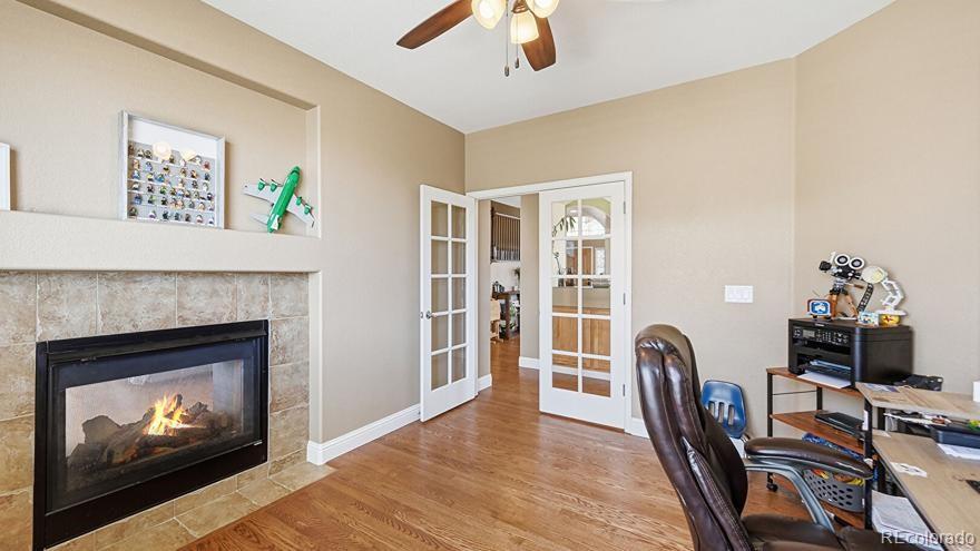 7869 Solstice Way Castle Rock, CO 80108 - Photo 11 of 41 a living room with furniture a flat screen tv and a fireplace