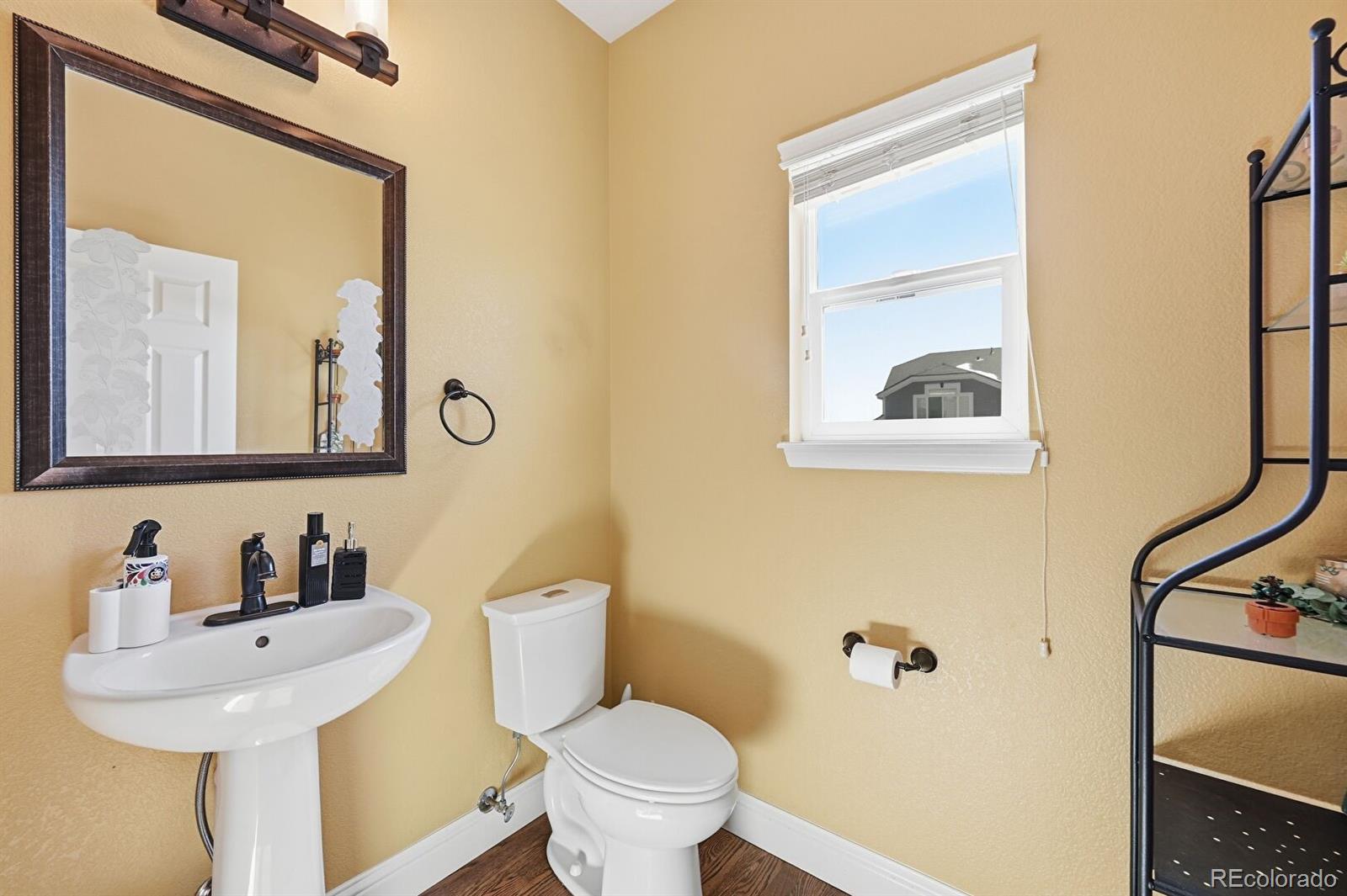 7869 Solstice Way Castle Rock, CO 80108 - Photo 17 of 41 a bathroom with a toilet sink and mirror
