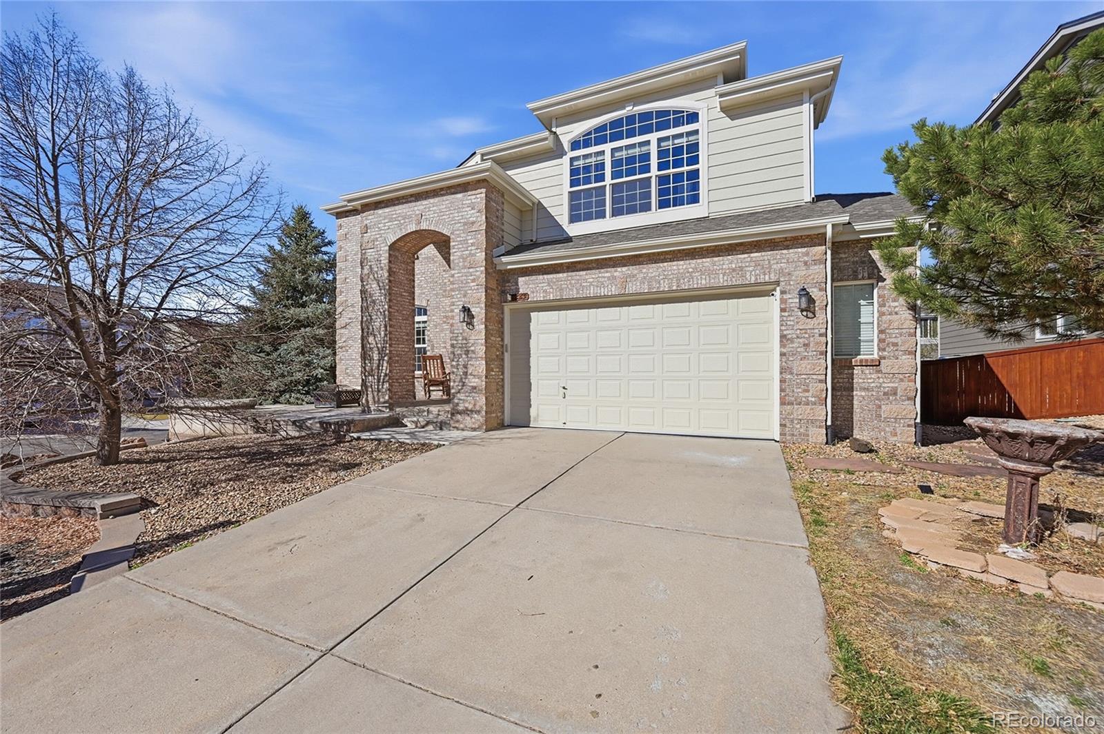 7869 Solstice Way Castle Rock, CO 80108 - Photo 2 of 41 a front view of a house with parking space
