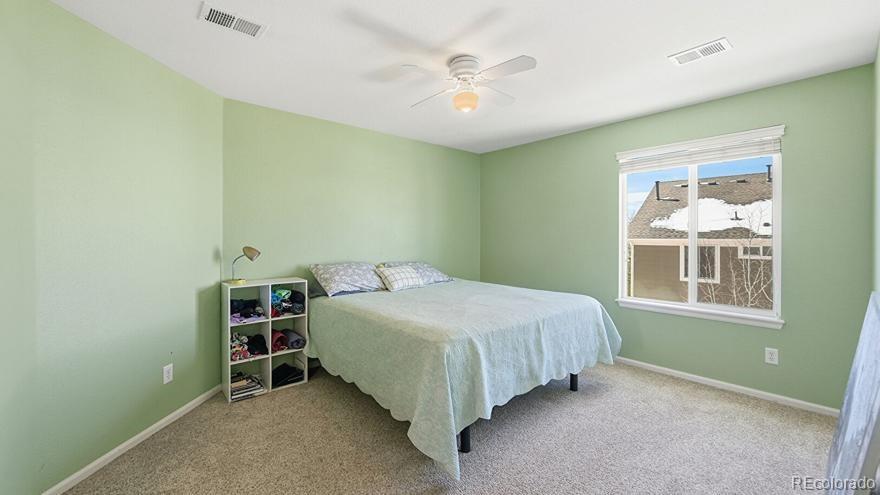7869 Solstice Way Castle Rock, CO 80108 - Photo 25 of 41 a bedroom with a bed and a window