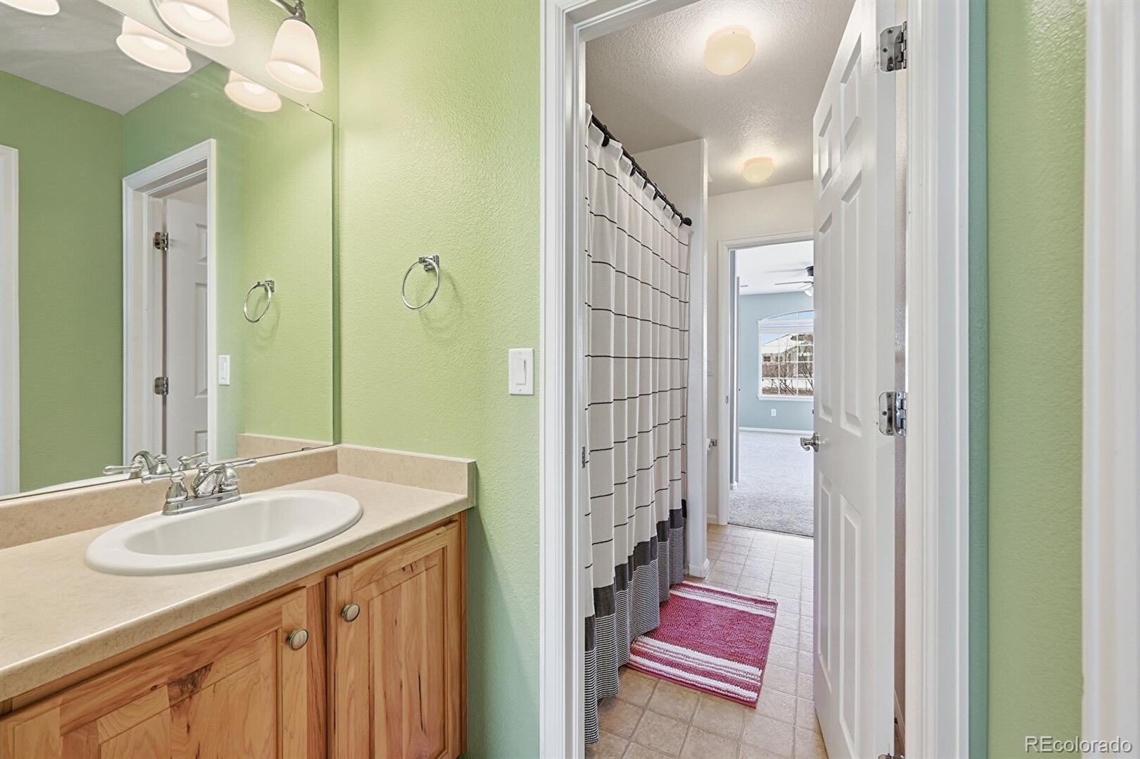 7869 Solstice Way Castle Rock, CO 80108 - Photo 26 of 41 a bathroom with a sink double vanity and a mirror