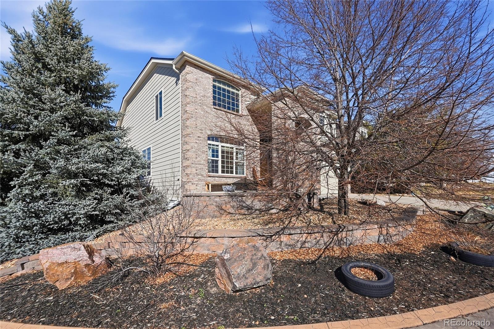 7869 Solstice Way Castle Rock, CO 80108 - Photo 3 of 41 a front view of a house with yard
