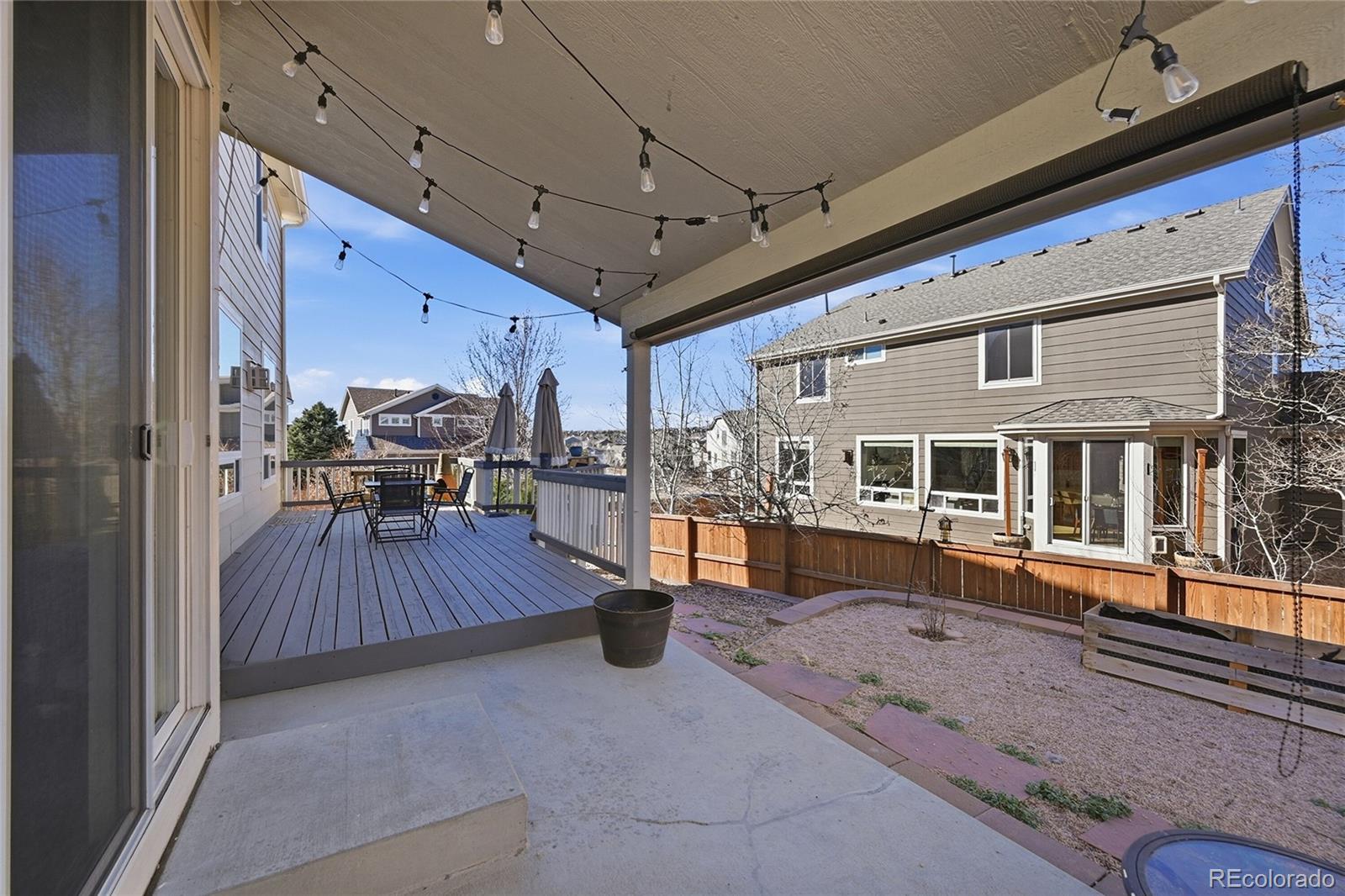 7869 Solstice Way Castle Rock, CO 80108 - Photo 38 of 41 a view of a patio with wooden floor and seating space