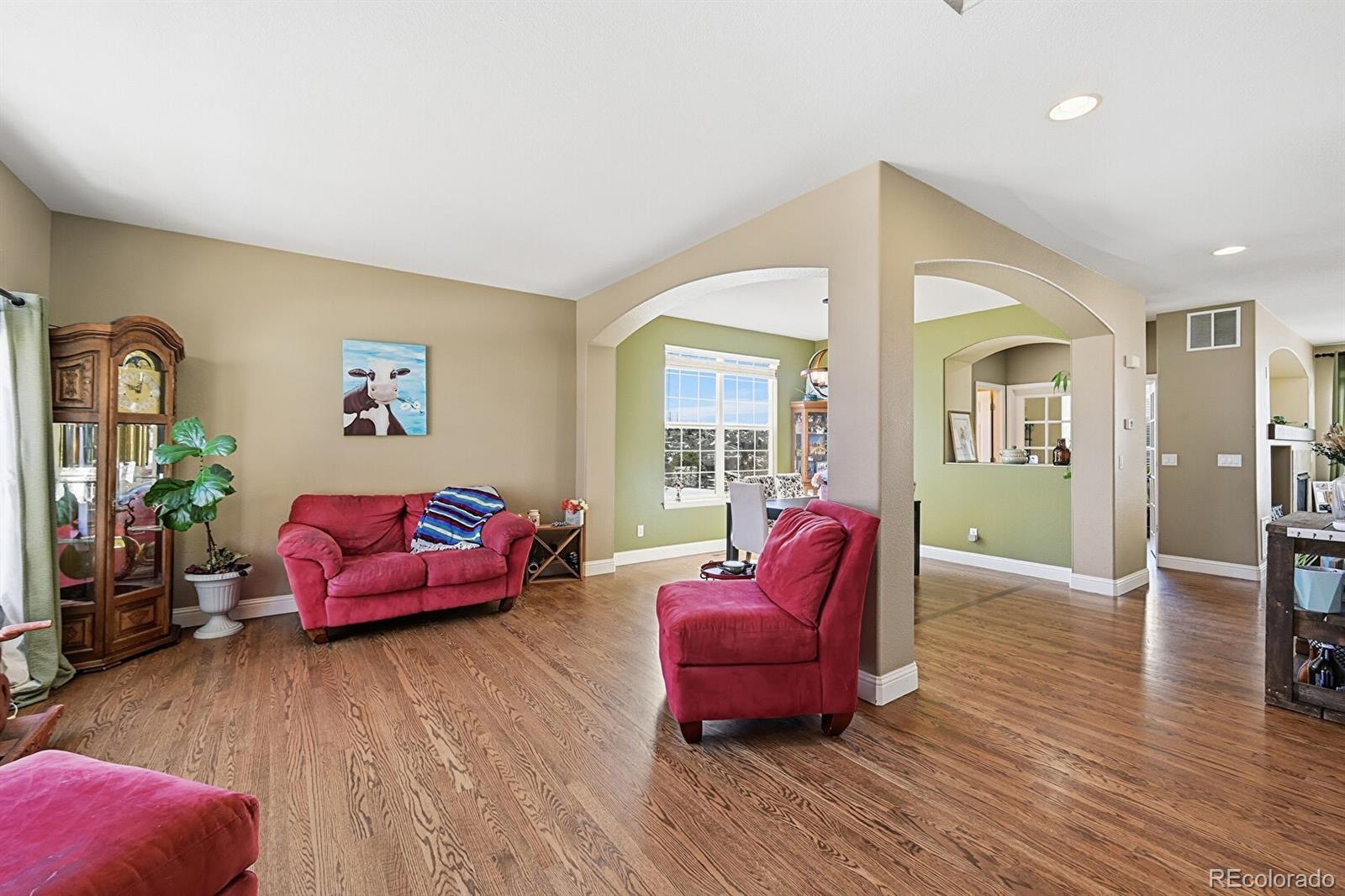 7869 Solstice Way Castle Rock, CO 80108 - Photo 6 of 41 a living room with furniture and wooden floor