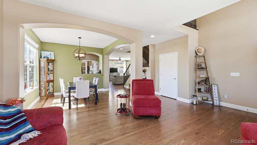 7869 Solstice Way Castle Rock, CO 80108 - Photo 7 of 41 a living room with furniture and wooden floor