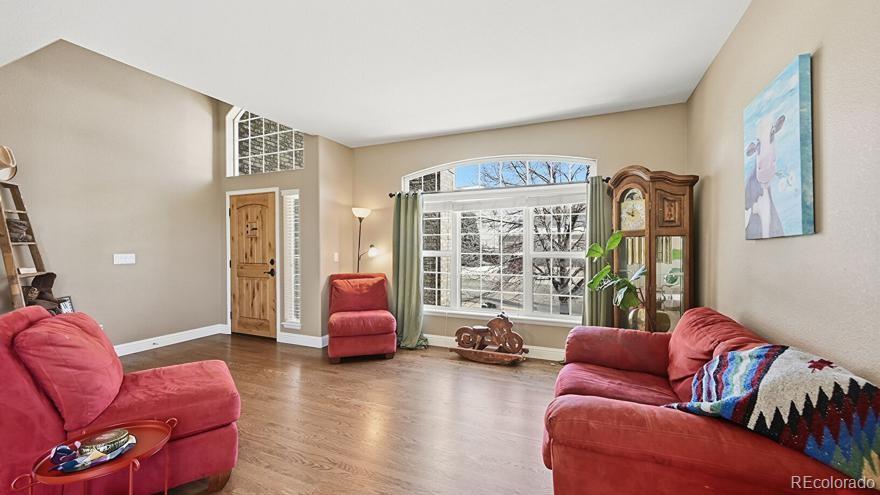 7869 Solstice Way Castle Rock, CO 80108 - Photo 8 of 41 a living room with furniture and a large window