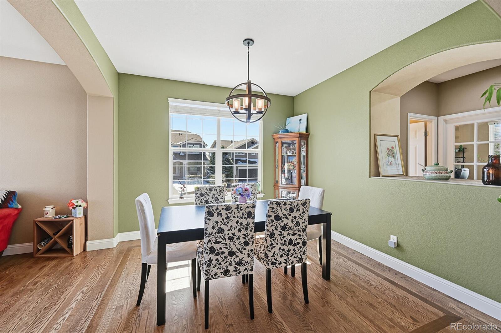 7869 Solstice Way Castle Rock, CO 80108 - Photo 10 of 41 a view of a dining room with furniture window and wooden floor