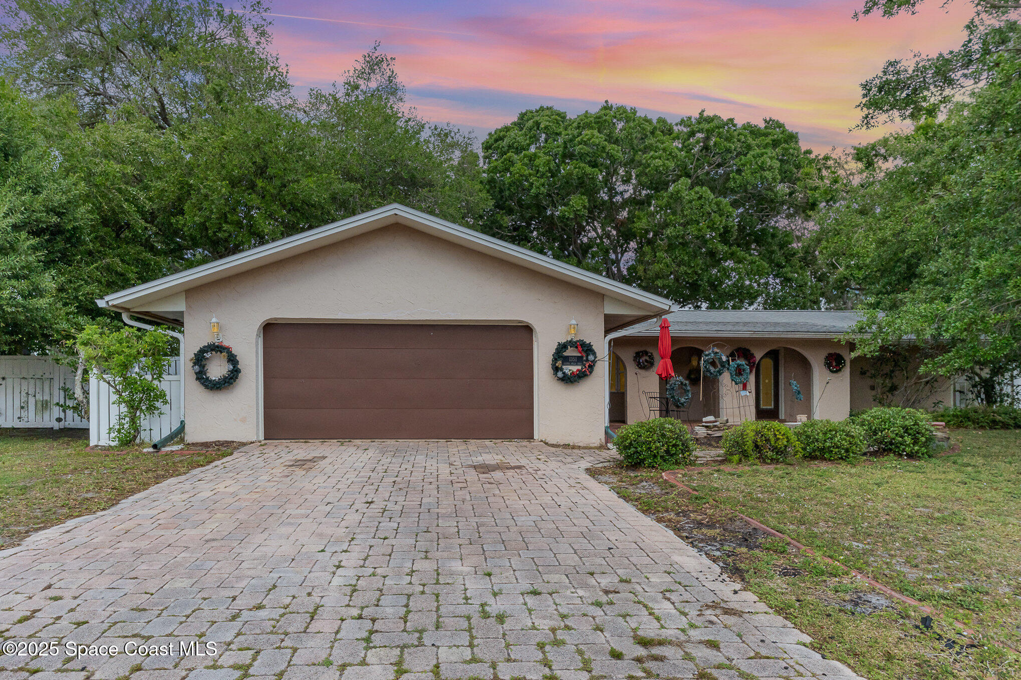 1351 Cherry Hills Road Northeast Palm Bay, FL 32905 - Photo 1 of 27 a front view of house with yard and trees in the background