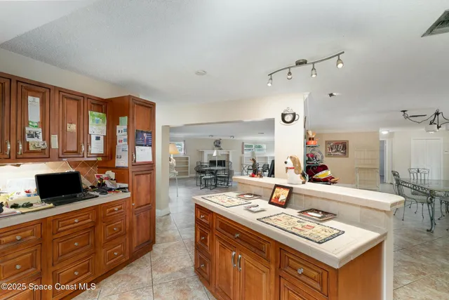 a living room with stainless steel appliances kitchen island granite countertop a stove and a sink