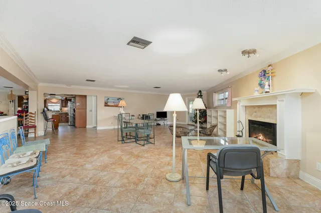 a living room with furniture a fireplace and a table