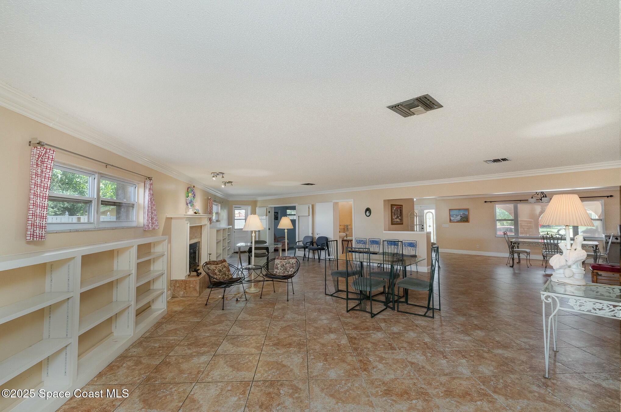 1351 Cherry Hills Road Northeast Palm Bay, FL 32905 - Photo 16 of 27 a living room with furniture and a dining table with kitchen view