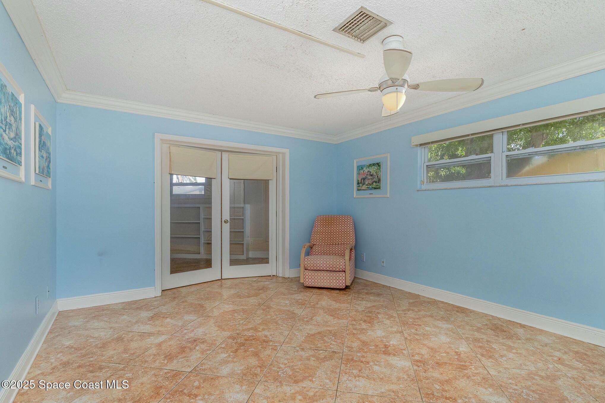 1351 Cherry Hills Road Northeast Palm Bay, FL 32905 - Photo 18 of 27 a view of room with ceiling fan and window