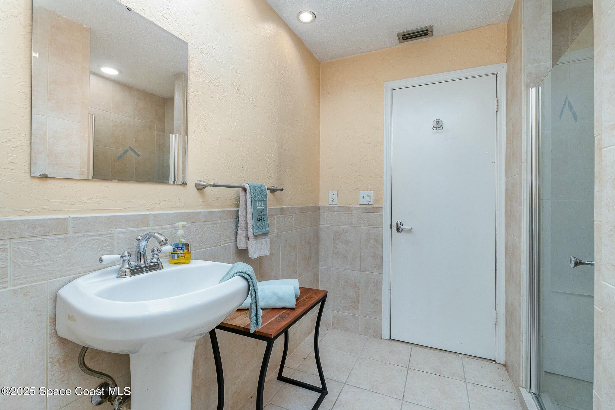 1351 Cherry Hills Road Northeast Palm Bay, FL 32905 - Photo 19 of 27 a bathroom with a sink and a mirror