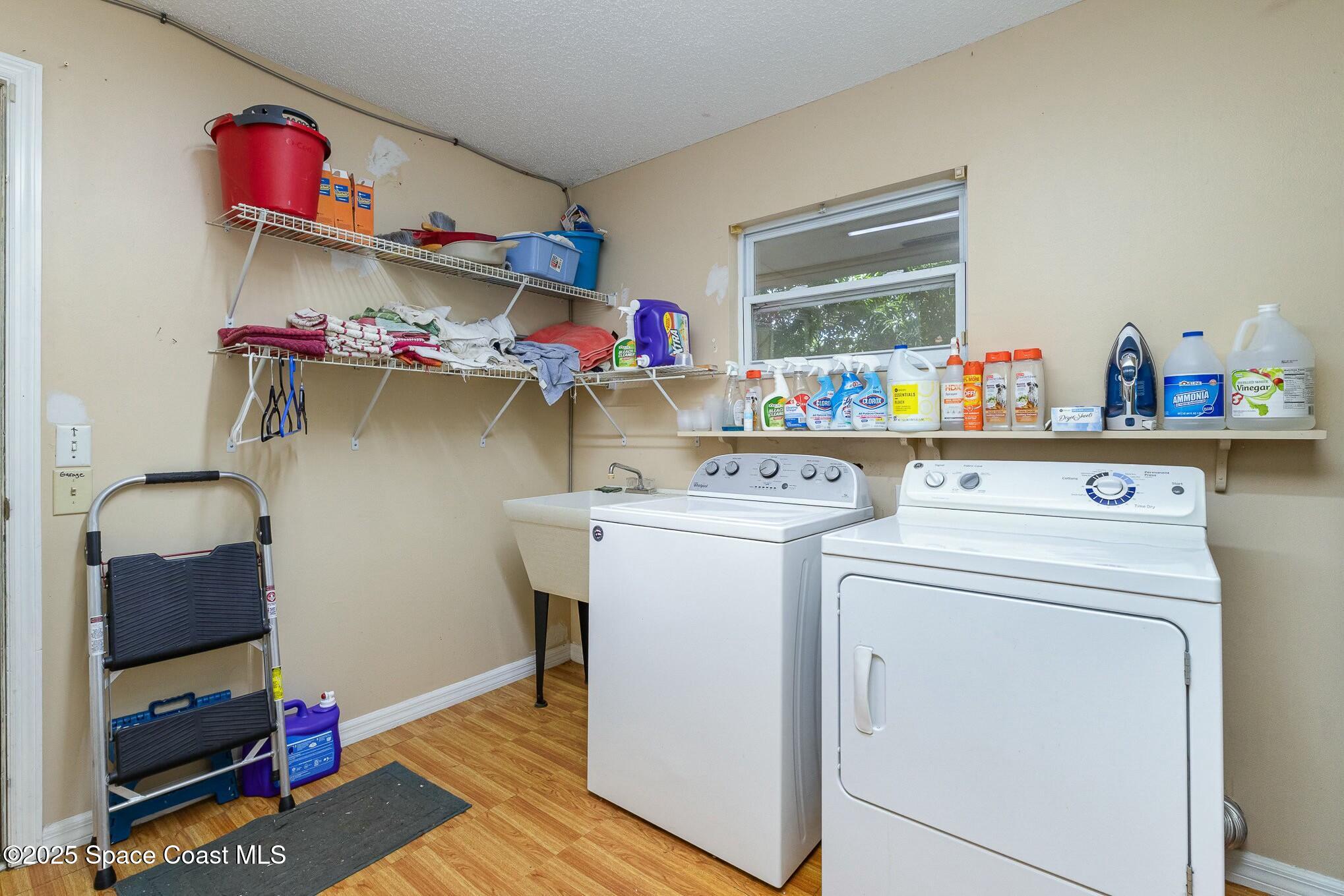 1351 Cherry Hills Road Northeast Palm Bay, FL 32905 - Photo 23 of 27 a utility room with dryer and washer