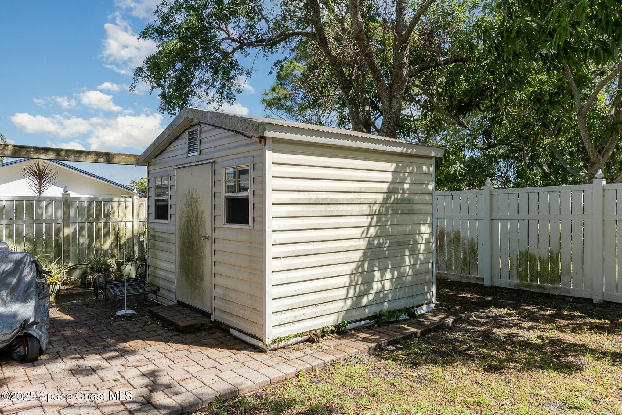 1351 Cherry Hills Road Northeast Palm Bay, FL 32905 - Photo 26 of 27 a view of a house with a yard