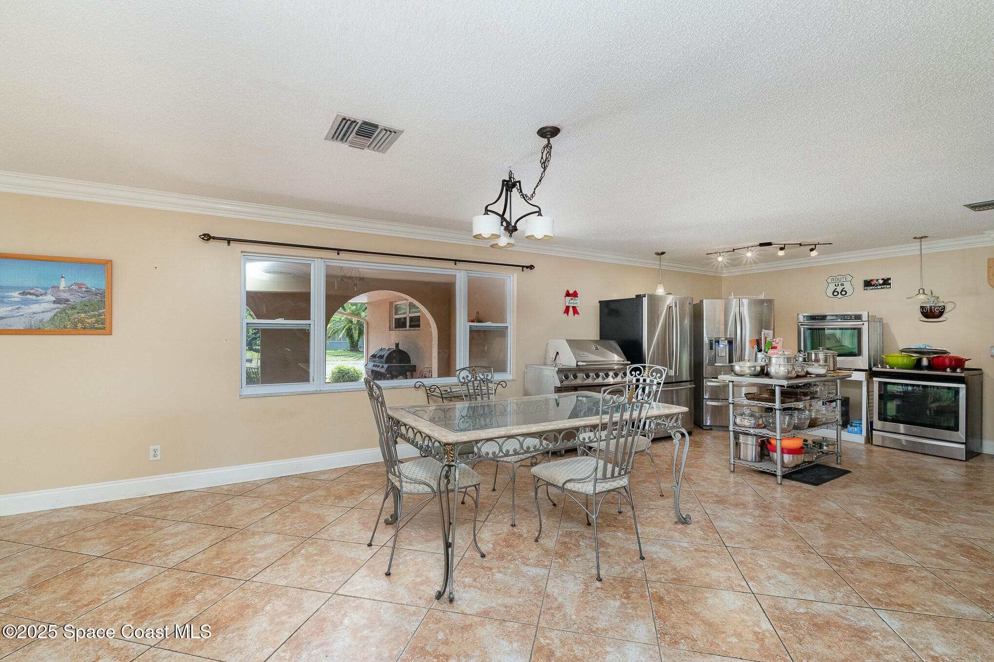 1351 Cherry Hills Road Northeast Palm Bay, FL 32905 - Photo 6 of 27 a view of a dining room with furniture