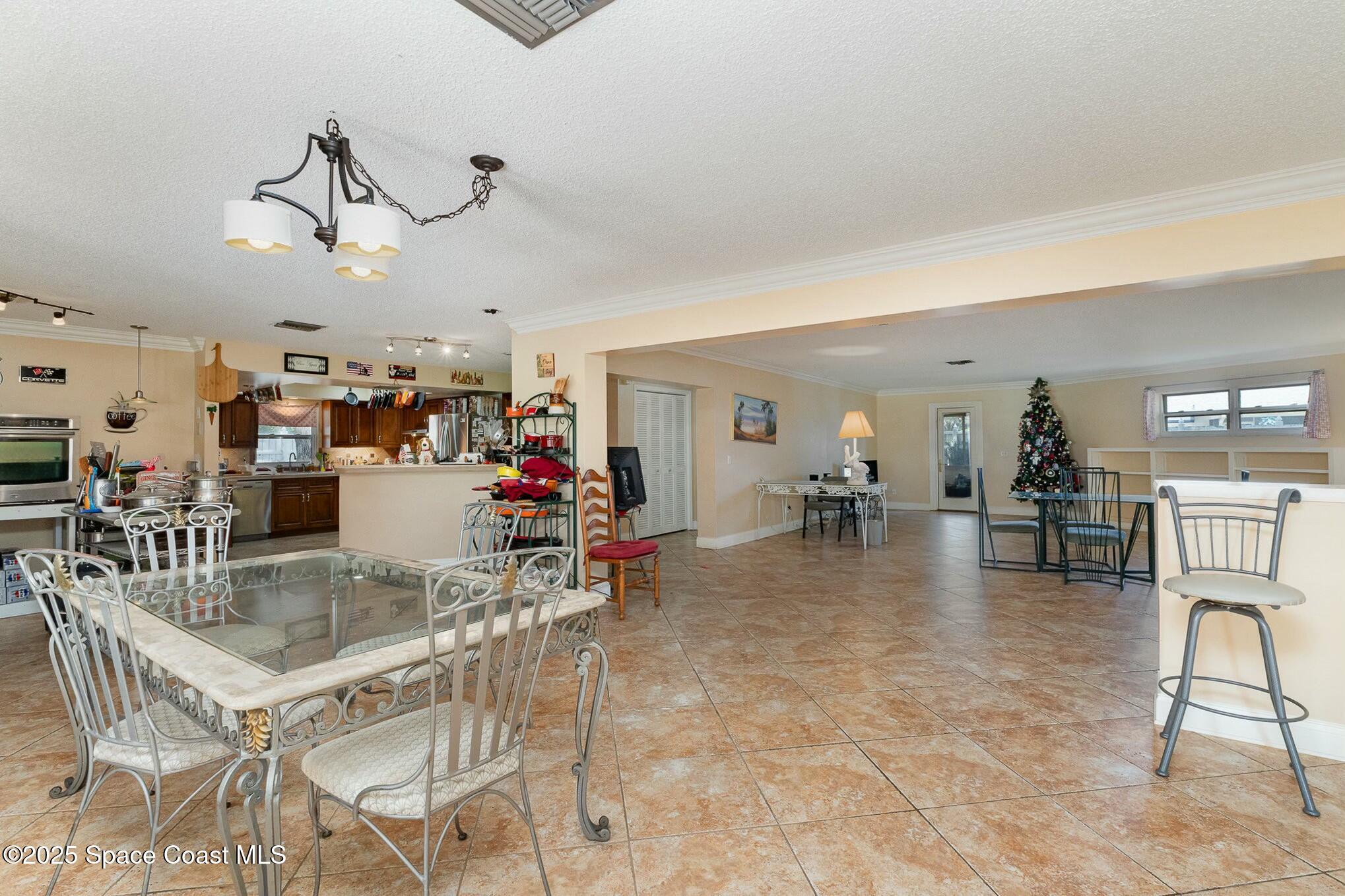 1351 Cherry Hills Road Northeast Palm Bay, FL 32905 - Photo 7 of 27 a view of a dining room with furniture
