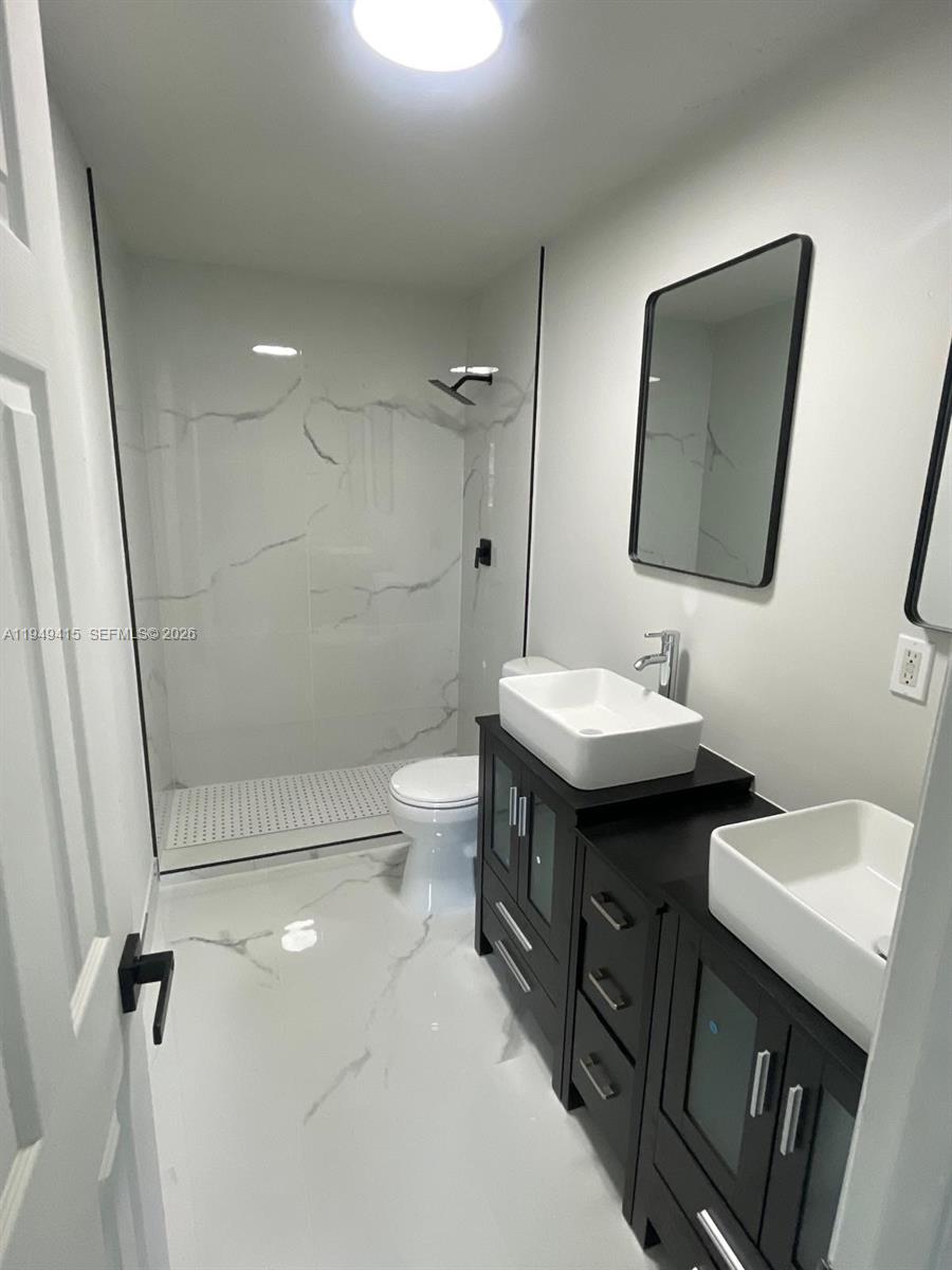 14964 Southwest 305th Terrace Homestead, FL 33033 - Photo 4 of 4 a bathroom with a sink a toilet and shower