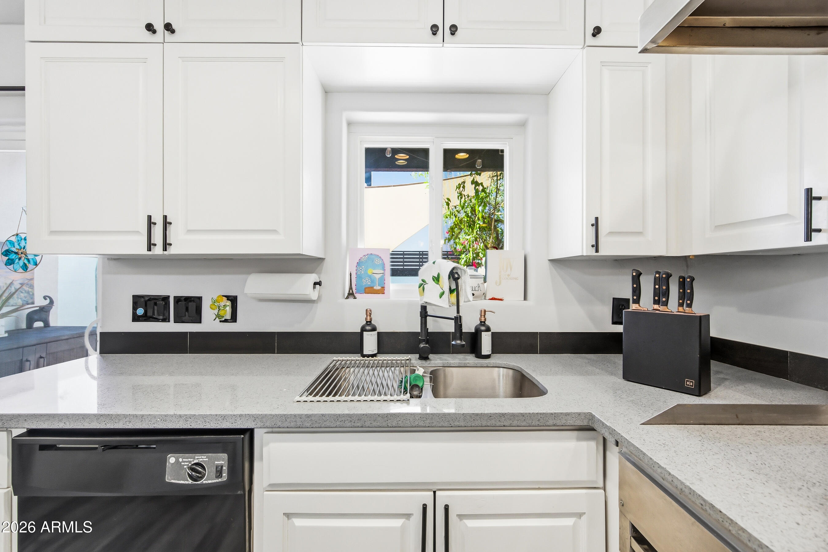 1702 East Ocotillo Road, Unit 1 Phoenix, AZ 85016 - Photo 11 of 27 a kitchen with stainless steel appliances granite countertop a sink a stove and a white cabinets