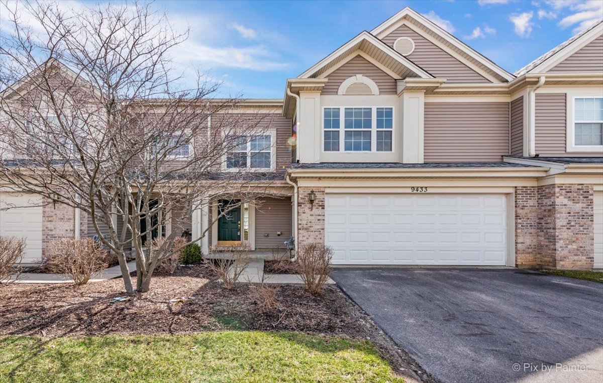 9433 Rainsford Drive, Unit 9433 Huntley, IL 60142 - Photo 1 of 30 a view of a white house with large windows