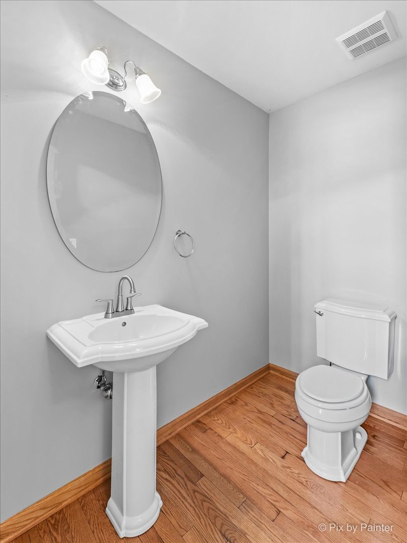 9433 Rainsford Drive, Unit 9433 Huntley, IL 60142 - Photo 15 of 30 a bathroom with a toilet sink and mirror