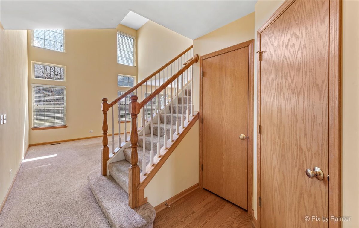 9433 Rainsford Drive, Unit 9433 Huntley, IL 60142 - Photo 16 of 30 a view of entryway with wooden floor and stairs