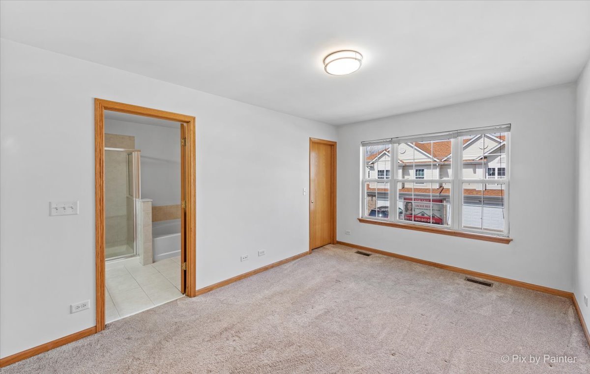 9433 Rainsford Drive, Unit 9433 Huntley, IL 60142 - Photo 18 of 30 a view of an empty room with a window