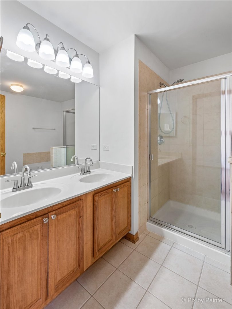 9433 Rainsford Drive, Unit 9433 Huntley, IL 60142 - Photo 20 of 30 a bathroom with a double vanity sink mirror and shower