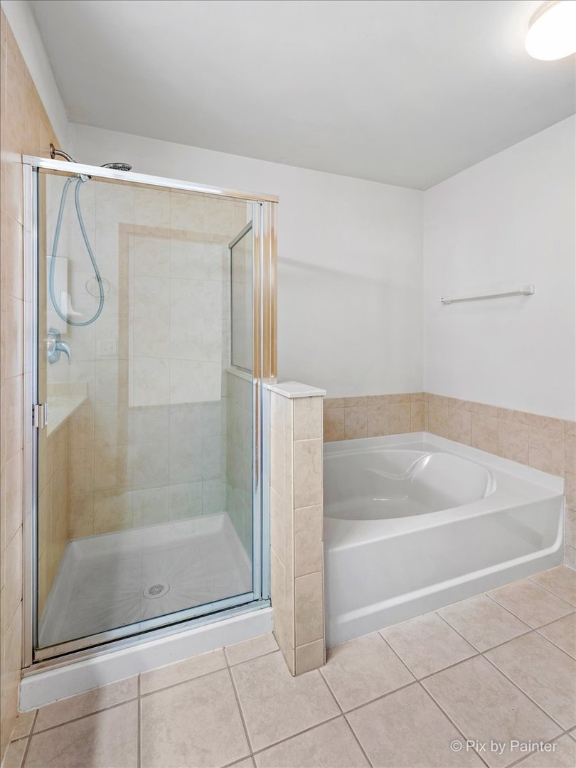 9433 Rainsford Drive, Unit 9433 Huntley, IL 60142 - Photo 21 of 30 a bathroom with a shower and a bath tub