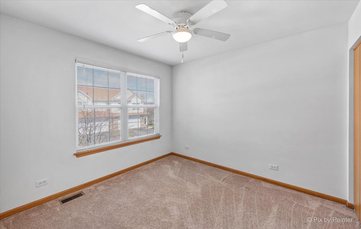 9433 Rainsford Drive, Unit 9433 Huntley, IL 60142 - Photo 22 of 30 an empty room with a window and a fan