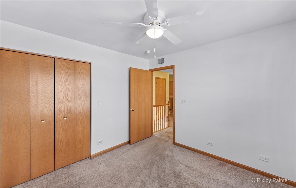9433 Rainsford Drive, Unit 9433 Huntley, IL 60142 - Photo 23 of 30 an empty room with a ceiling fan and a window