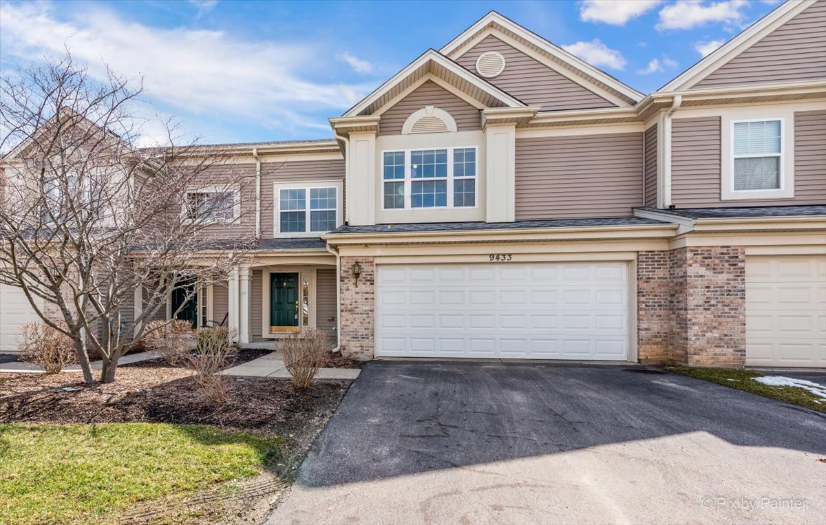 9433 Rainsford Drive, Unit 9433 Huntley, IL 60142 - Photo 27 of 30 a front view of a house with a yard and garage