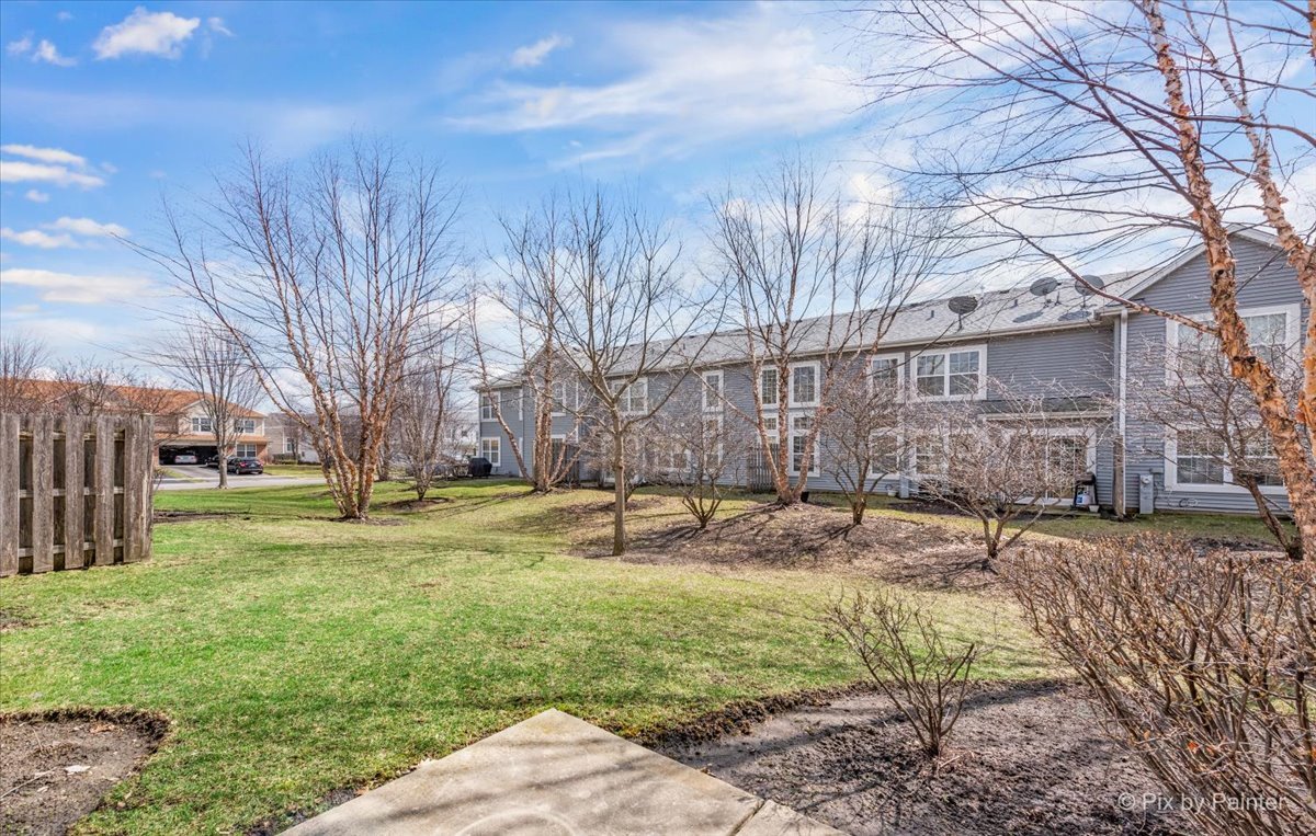9433 Rainsford Drive, Unit 9433 Huntley, IL 60142 - Photo 5 of 30 a view of a yard with a house and a tree