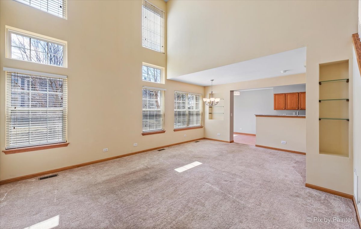 9433 Rainsford Drive, Unit 9433 Huntley, IL 60142 - Photo 7 of 30 a view of an empty room with a window