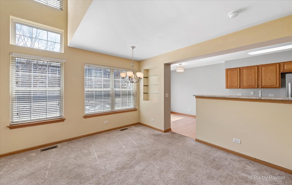 9433 Rainsford Drive, Unit 9433 Huntley, IL 60142 - Photo 8 of 30 a view of an empty room with a window