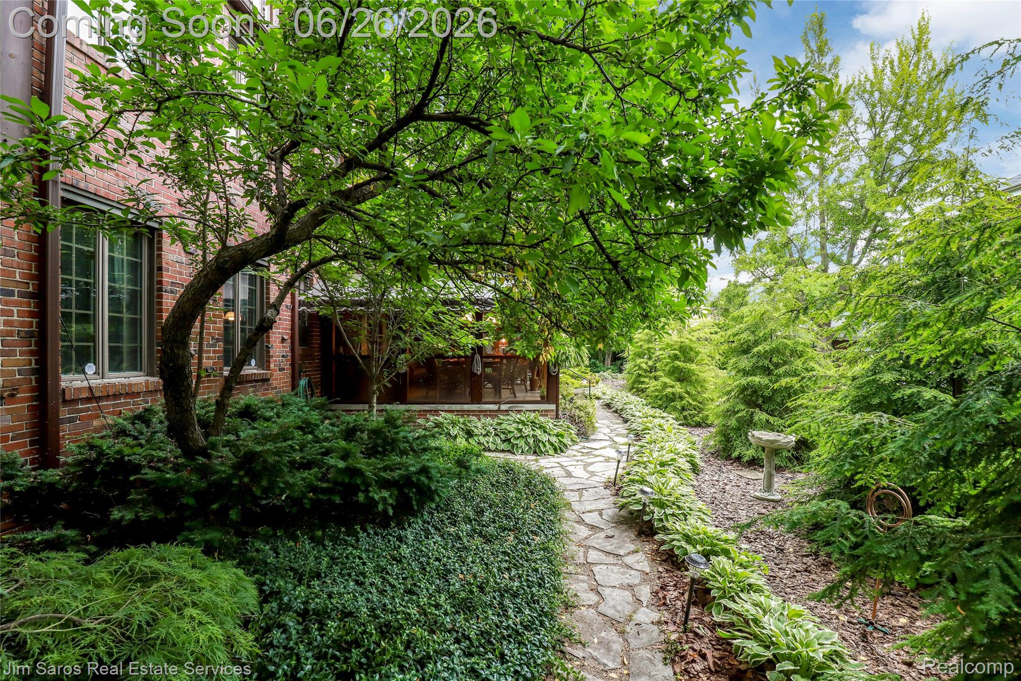 764 Harcourt Road Grosse Pointe, MI 48230 - Photo 40 of 42 Stone pathway bordered by hostas and ground cover, leading through mature landscaping