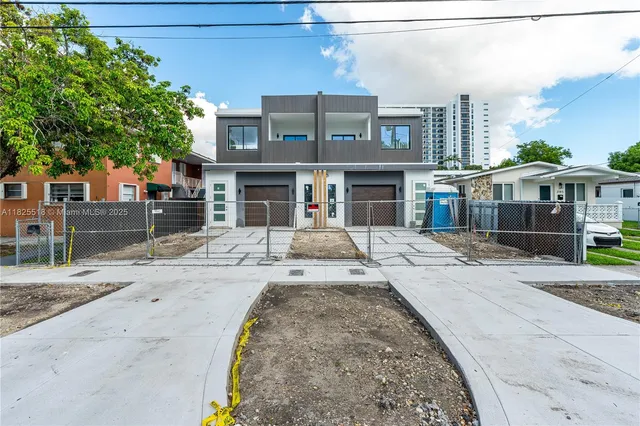 a view of a brick building next to a yard