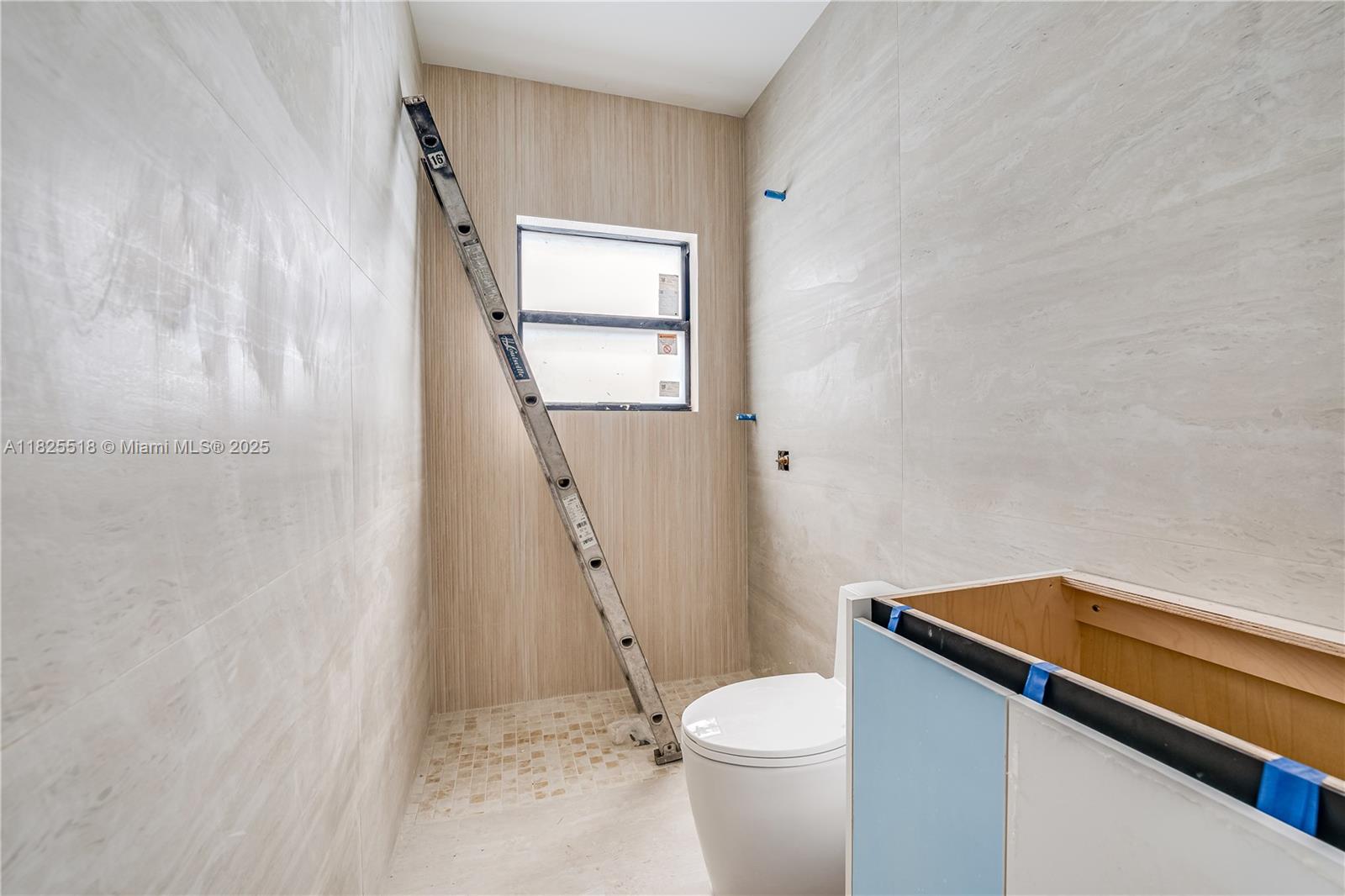 3187 Southwest 23rd Street, Unit A Miami, FL 33145 - Photo 9 of 18 a bathroom with a sink a toilet and shower