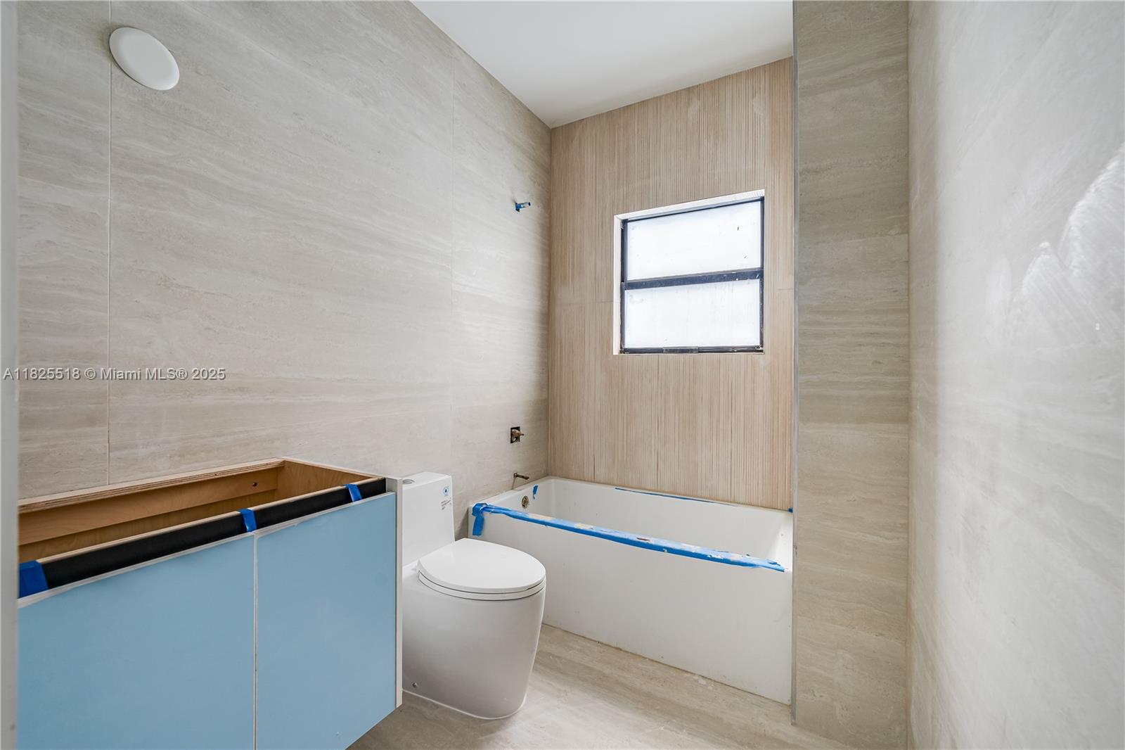 3187 Southwest 23rd Street, Unit A Miami, FL 33145 - Photo 10 of 18 a bathroom with a toilet a sink and mirror