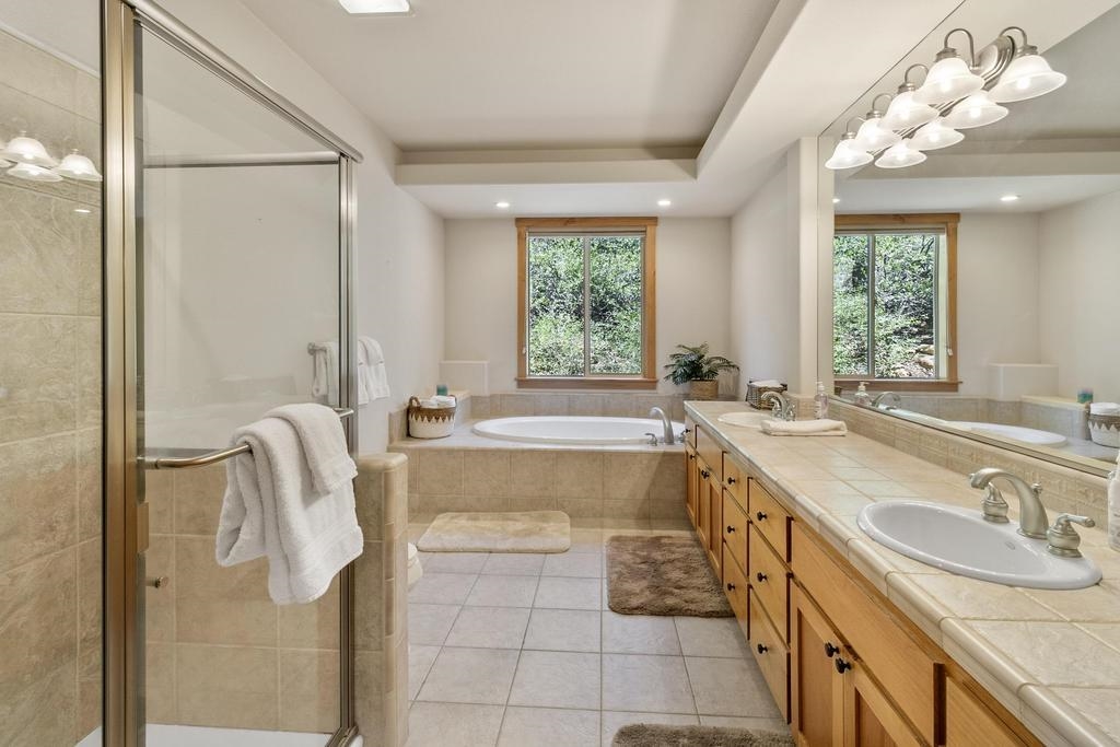 11347 Ski Slope Way Truckee, CA 96161 - Photo 18 of 21 a spacious bathroom with a tub sink and mirror