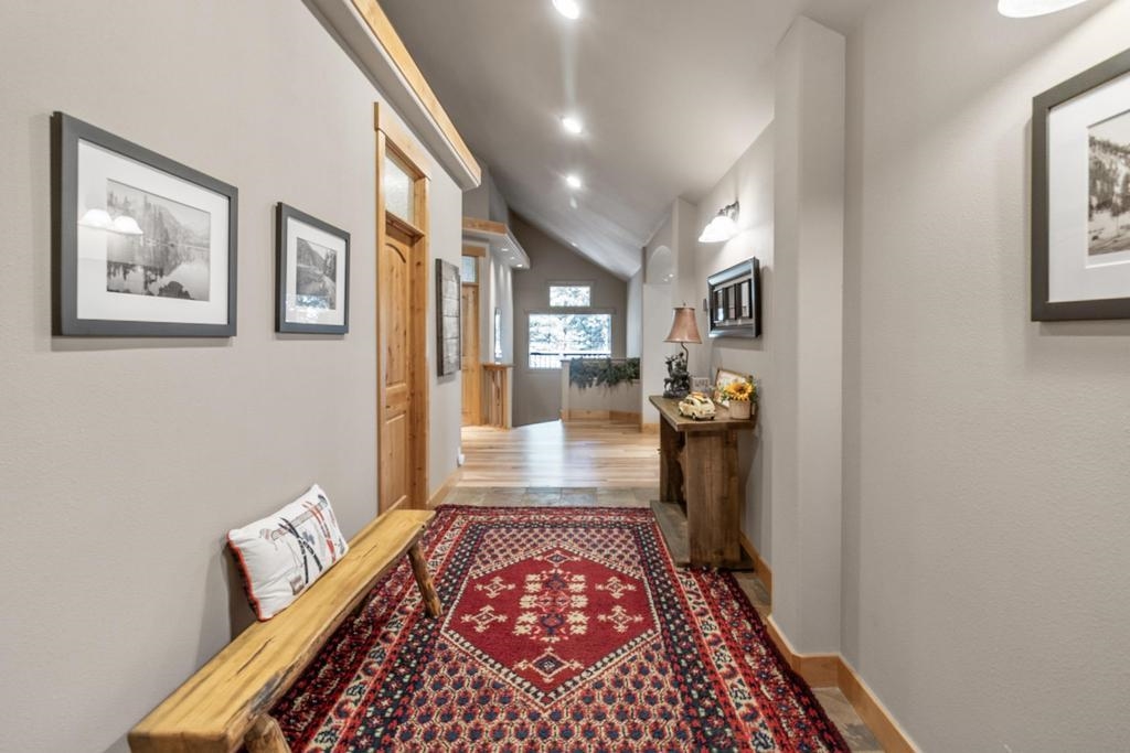 11347 Ski Slope Way Truckee, CA 96161 - Photo 3 of 21 a hallway with a large mirror and a rug