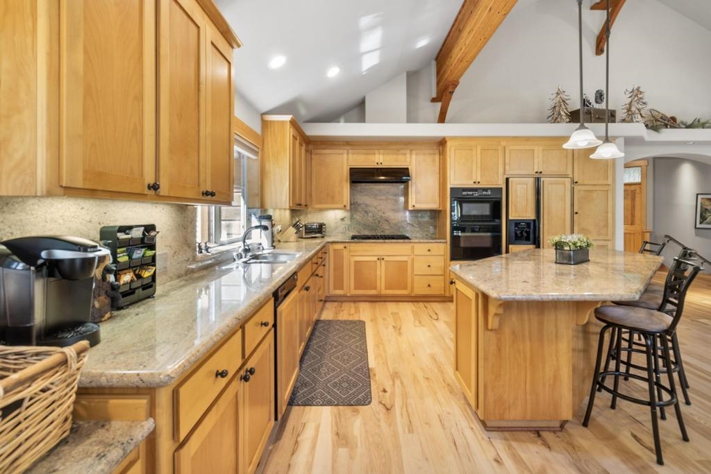 11347 Ski Slope Way Truckee, CA 96161 - Photo 10 of 21 a view of a kitchen with kitchen island granite countertop a large window a sink and counter space