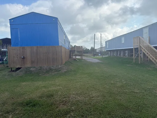 a view of a small yard and a car parked in the yard