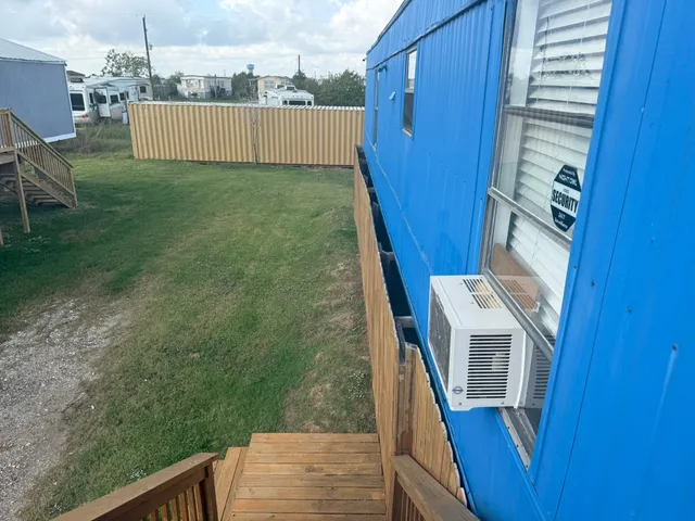 a view of balcony and wooden fence