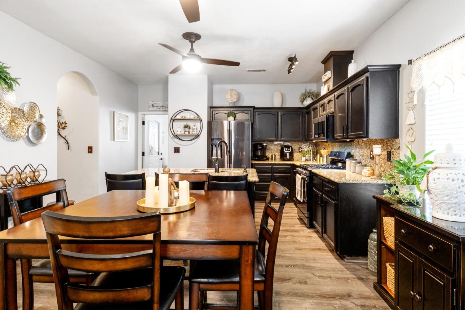2658 Kimberly Drive Madera, CA 93637 - Photo 12 of 27 a view of a dining room with furniture and wooden floor